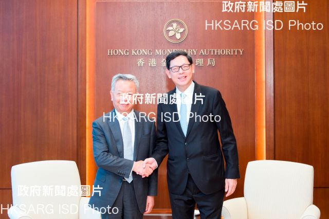 The Chief Executive of the Hong Kong Monetary Authority, Mr Norman Chan (right), meets with the President of the Asian Infrastructure Investment Bank, Mr Jin Liqun (left), today (July 18).