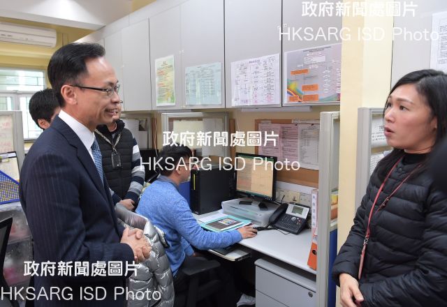 The Secretary for Constitutional and Mainland Affairs, Mr Patrick Nip (left), talks to a staff member of the hotline service centre for sexual minorities operated by the Tung Wah Group of Hospitals today (February 12) to learn about its call-handling situation.
