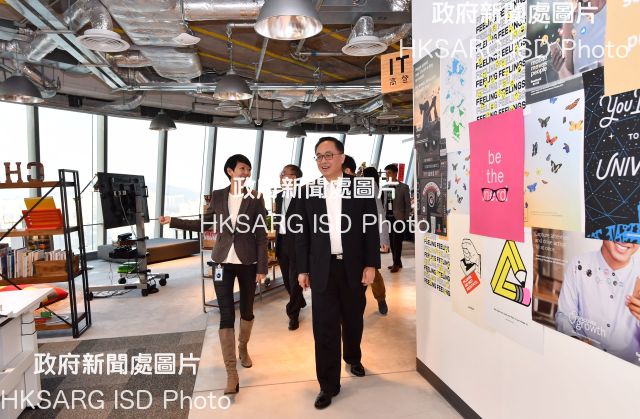 The Secretary for Information and Technology, Mr Nicholas W Yang (right), is given a guided tour by Facebook's Head of Greater China, Ms Jayne Leung (left), at the Hong Kong headquarters of Facebook today (February 13).