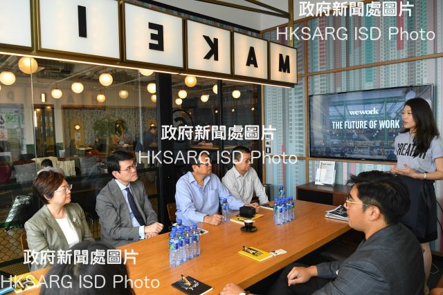 The Secretary for Commerce and Economic Development, Mr Edward Yau, toured the co-working space set up by WeWork in Causeway Bay during his visit to Wan Chai District today (July 9). Photo shows Mr Yau (second left); the District Officer (Wan Chai), Mr Rick Chan (fourth left); the Chairman of Wan Chai District Council, Mr Stephen Ng (third left); and the Vice-chairman of Wan Chai District Council, Dr Jennifer Chow (first left), being briefed by representatives from WeWork on their operations.