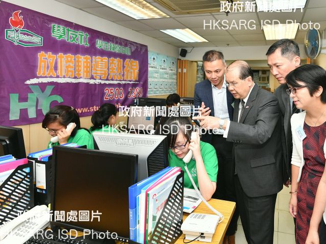 The Chief Secretary for Administration, Mr Matthew Cheung Kin-chung, today (July 11) visited the Hok Yau Club's Student Guidance Centre. Photo shows Mr Cheung (third right) being briefed by the Director of the Centre, Mr Ng Po-shing (fourth right) on the operation of a dedicated counselling hotline and the support the Centre renders to the current-year candidates of the Hong Kong Diploma of Secondary Education Examination, including providing study information and counselling service.