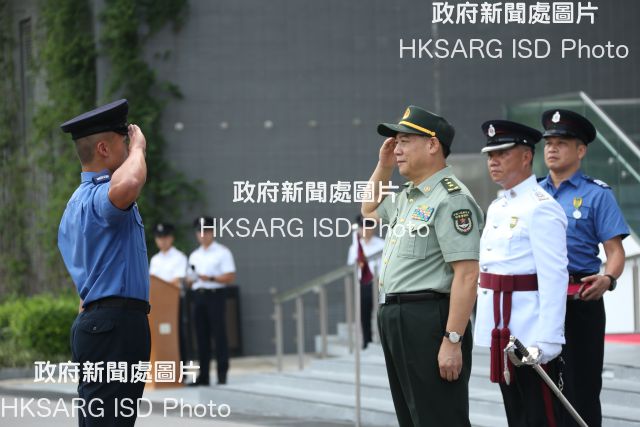 The Commander-in-chief of the Chinese People's Liberation Army Hong Kong Garrison, Lieutenant General Tan Benhong, reviews the 183rd Fire Services passing-out parade at the Fire and Ambulance Services Academy today (September 7). Photo shows Mr Tan (third right) presenting the Best Recruit award to a graduate.
