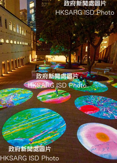 Visitors walk over immersive moving image installations in the 'Behind Your Eyelid - Pipilotti Rist' exhibition at various locations in Tai Kwun.